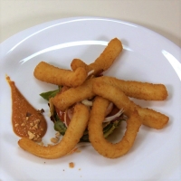 Breaded squid sticks with romesco sauce