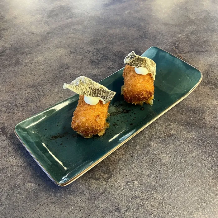 Cod croquette (La Islandesa - Gastrobar) with leek confit and its crispy skin