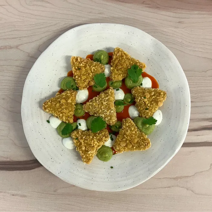 Tijuana chicken nachos with tomato, guacamole and cheese